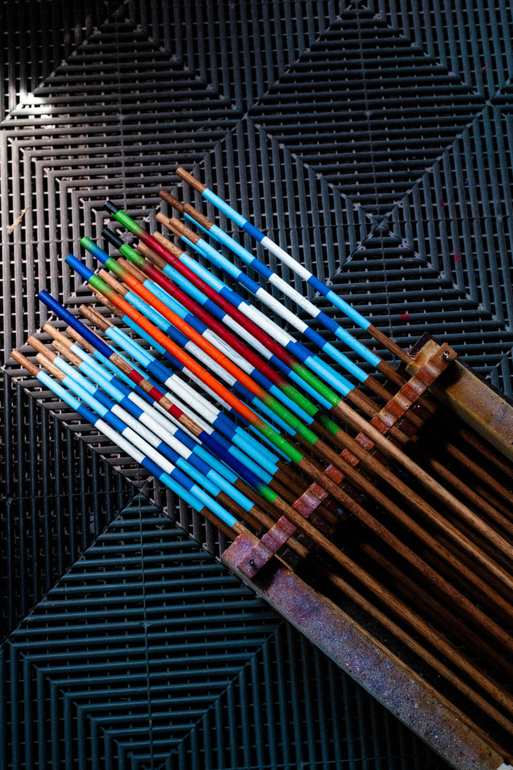 A colorful selection of hand-painted Hazy Golf alignment sticks in the workshop.